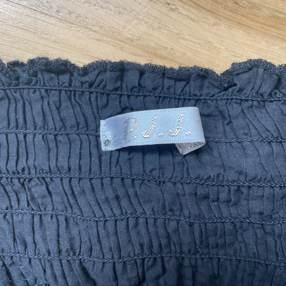 gullig blus med broderade blommor passar jättebra till en kjol eller över ett par jeans . Puserot.