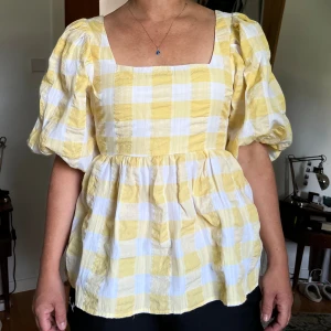 Gul blus - Rutig blus med puffärmar och rosett där bak. Fint skick. Storlek M men kan också passa S 💛💛