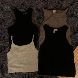 Paketpris 4 linnen - Säljer dessa 4 linnen i ett paket. Alla i storlek XS. De två helsvarta linnena är ifrån H&M, ett ribbat o ett slätt. Det upp till höger är svartvitt randigt från Monki och det ner till vänster är från NewYorker och är ljusblått. 40kr för alla.
