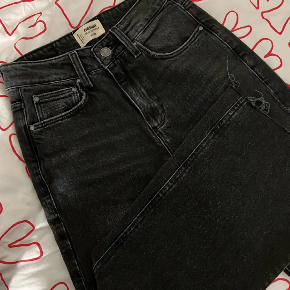 Svarta urtvättade/mörkgråa straight jeans med en liten slits längst ner. Köpta på Zalando. De är mid-waisted och sitter bra på kroppen. Endast använda 1 gång, så dem är i väldigt gott skick. Se första bilden där jag har på mig dem :). Jeans & Byxor.