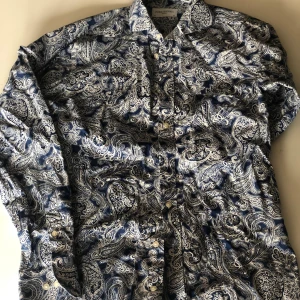 John Henric skjorta stl 38 - Skjorta från John Henric i nyskick. Blå och vitblommig, stl 38