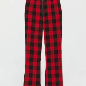 svart och röd rutiga utsvängda byxor med dragkedja i storlek 38. Aldrig använda och i perfekt skick