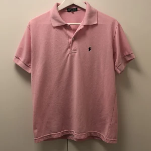 Ralph lauren pike - Rosa ralph lauren pike i bra skick. Äldre modell där av priset. Men är fortfarande i grymt skick. Storlek M men passar något mindre.