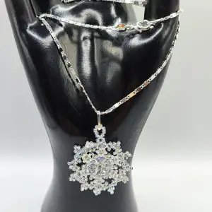 Min mamma tillverkar och designar egna smycken. Denna vackra snöflinga är vävd i små glaspärlor. Kedjan i äkta silver och 44 cm lång. Hänget är 4 cm. 