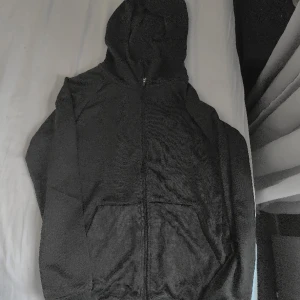 Träningsjacka/tröja med dragkedja  - Tunn träningsjacka/tröja i superskönt material! I superfint skick. Strl 146/152. Färgen är mörkgrå.