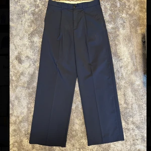 Kostymbyxor loose - Mörkblåa kostymbyxor från weekday som är använda några gånger men är i mycket bra skick.  Byxorna har en ledig passform. Jag är ca 180cm och de passar mig bra. 