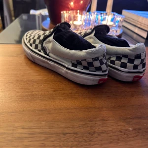 Vans slip on - Klassiska Vans Slip On i schackrutigt mönster. Bra använt skick. Strlk 34