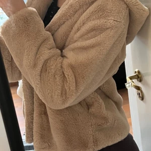 Mjuk beige pälsjacka  - Supersjuk jacka i fuskpäls och luva Storlek M Pimkie, köpt för 400kr Stängs m knappar Obs: den lägsta knappen är sönder, men det syns inte när man har på sig jackan