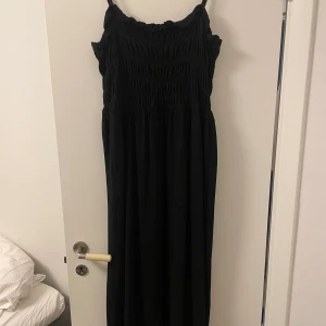 Midklänning - Medium lång svart klänning som är använd en gång och är i ett väldigt bra skick. I ett väldigt mjukt material!