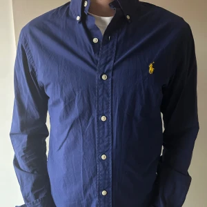 Polo Ralph Lauren skjorta - Ralph Lauren skjorta i grymt snygg marinblå färg i skönt material perfekt för sommarkvällarna!  🔵stilren marinblå färg🔵 🙌🏽Grymt skick (8-9/10)🙌🏽 🌊storlek S, passar S🌊 Hör gärna av er vid fler bilder eller vid minsta lilla fundering🕺 Allt gott  Mvh  