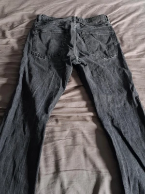 Grå raka jeans från 157 - Säljer ett par grå jeans från 157 med raka ben och klassisk femficksmodell. Jeansen har en snygg tvättad look och är tillverkade i denim. Perfekta för en avslappnad och trendig stil.