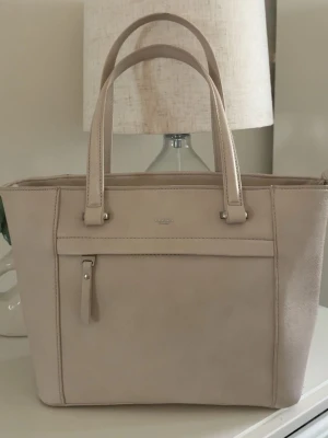 Beige väska  - jätte snygg beige handväska från Ulrika. perfekt nu till skolstarten, Aldrig använd. Den är äkta 