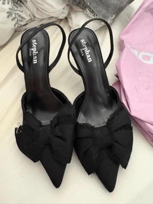 Svarta pumps med rosett  - Helt nya svarta pumps klackskor, fick hem dem i veckan men dem va lite för stora för mig. Dem är endast testade! 