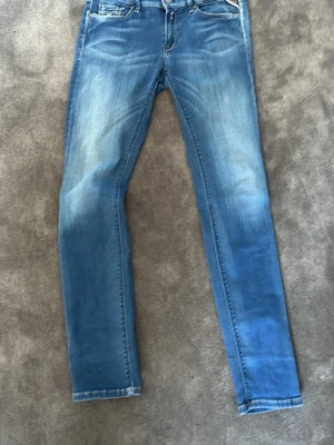 Blås replay jeans  - Snygga blå slim fit jeans med klassiska fem fickor. Jeansen har en smal passform och normal midja. Perfekta för en avslappnad och trendig look. små fickor ifram.