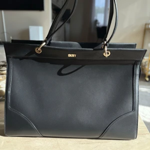 DKNY GRAMERCY SATCHEL SM - DKNY GRAMERCY SATCHEL SM som ny. Använd endast vid fåtal tilltfällen. Dustbag medföljer samt helt ny axelrem. Nypris: 4699 kr (slutsåld modell i butik)