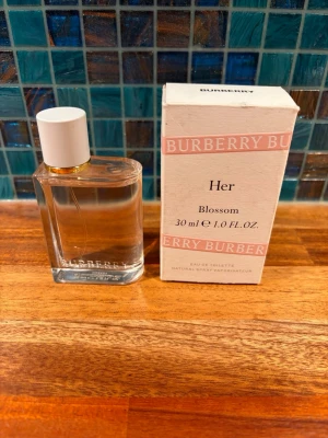 Burberry Blossom parfym 30 ml - Burberry Blossom, edp, 30ml, som ny! Fräsch parfym från Burberry i en stilren, transparent glasflaska med vit kork och gulddetalj. Doften har toppnoter av mandarin och rosa peppar, hjärtnoter av pion och plommonblomma samt basnoter av mysk och sandelträ. Flaskan rymmer 30 ml.