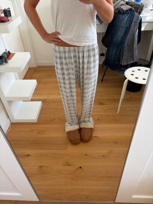 Rutiga pyjamasbyxor - Ljusgråa och vita rutiga pyjamasbyxor i storlek XS. Pösiga i modellen och tunna i materialet. Använda men fint skick.