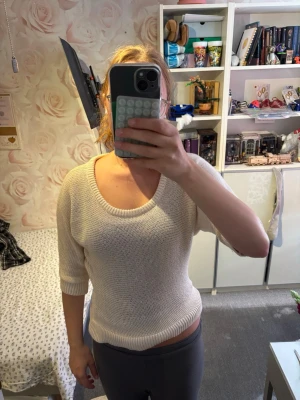 Beige stickad tröja med 3/4-ärm - Säljer en enkel och stilren beige stickad tröja med rund halsringning och trekvartsärmar. Tröjan har en rak passform och ribbade muddar vid ärmslut och nederkant. Perfekt att matcha med jeans eller kjol för en avslappnad look.