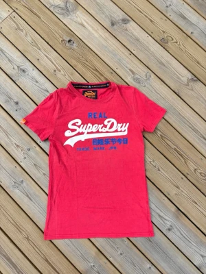 Superdry t shirt ~ Vintage  - Säljer denna Superdry t shirt i mycket br skick och som är Vintage. Storlek S. Passar perfekt för dig som är mellan 175-180! Hör av er vid frågor eller minsta fundering 🙌  Längd: 68 cm  Bred: 43 cm  Ärm: 17 cm