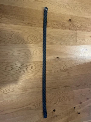 LV Bälte svart/grått - Säljer ett äkta LV Bälte i storlek 50/125. Jättefint bälte som jag har använt, vissa håll är lite sämre skick än andra, det beror på användningen, men annars jättefint. 24 karat silver, OBS - utan förpackning och taggar, de slängdes av mina föräldrar 