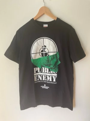 Supreme x Undercover Public Enemy tee - Public Enemy Supreme T-Shirt. Size medium, regular men’s medium fit. Great condition, no flaws or damage. Size measurements are L - 66cm, W - 49cm. Buyer pays for all shipping costs. All items sent with tracking number.   No swaps, no trades, no offers.  No 100 questions from 14 year olds either, it’s a cotton tee, it’s cheap, buy it!