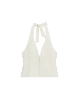Vit halterneck korsettopp med knyt - Stilren vit korsettopp med halterneck och knyt i nacken. Toppen har en djup v-ringning och markerad midja som ger en snygg siluett. Perfekt att matcha med jeans eller kjol för en trendig look. Helt ny med prislappen kvar