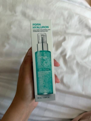 Anua PDRN Hyaluron Face Mist 100 ml - Fräsch ansiktsmist från Anua med PDRN och hyaluronsyra som återfuktar huden. Kommer i en genomskinlig blågrön flaska med spraypump och rymmer 100 ml. Perfekt för att ge huden extra fukt under dagen.