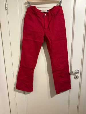 Röda bootcut från GAP - Något utsvängda vid smalbenen och lite kortare än vanliga jeans. Midjan är normal.