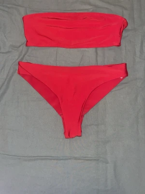 Röd bandeau bikini  - Säljer en snygg röd bandeau bikini från NAKD i storlek S. 💕