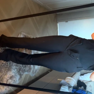 Svarta kostymbyxor från Bik Bok - Svarta kostymbyxor från Bik Bok i storlek 36. Byxorna har en rak och lite vidare passform med medium midja ..