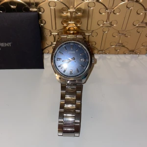CASIO klacka med marinblått ur och silver armband - En CASIO klocka, har haft den typ i 2 månader men kommer att den inte kommer till användning. Ny pris ligger på 998 kr , det var det priset jag köpte den för. Ni får man låda och länkar till den. PRISET ÄT INTE HUGGET I STEN!!!