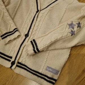 Oversized stickad Taylor Swift folklore kofta - Säljer denna fina Taylor Swift koftan då den inte längre kommer till användning. Den är storlek S på etiketten men skulle säga att den passar L om inte större då den är så oversized. Köpte den på etsy, den är alltså inte från taylorswift.com, därför det billiga priset💗