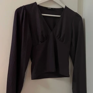 Topp från Bikbok - Säljer en fin tröja från Bik Bok med v-ringning och långa ärmar. Lila fin höstfärg 🤎