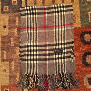 Vintage Burberry halsduk scarf  - -Riktigt bra skick. Nypris på dessa ligger på runt 5000kr, vilket gör detta till ett sjukt bra pris! Halsduken är gjord i Lamull, och är perfekt inför hösten och den kommande vintern. Anledningen till att det står ”Burberry’s” och inte ”Burberry” på lappen är eftersom halsduken är från några år tillbaka, innan de bytte namn! Om du har någon fråga är det bara att skriva till mig. /elgnce (4)