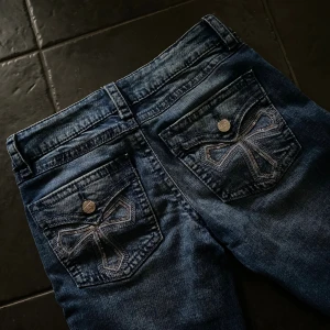 Blå jeans med broderade fickor - Snygga blå jeans från Gina Tricot. Jeansen har coola broderade detaljer på bakfickorna och silverfärgade knappar. I princip nya, använda 2-3 gånger 