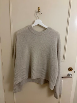 Beige stickad tröja med ribbad kant - Beige stickad tröja från ginatricot, storlek 170 men stor i storleken så passar mig med storlek S men kan även passa något större