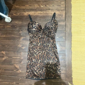 Leopardmönstrad korsettopp - Snygg leopardmönstrad korsettopp med smala axelband och vadderade kupor. Toppens material är stretchigt och följsamt, perfekt för att skapa en cool och trendig look. Färgerna går i brunt, svart och beige.