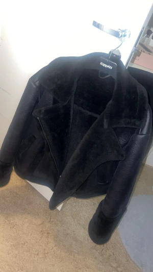 Svart pälsjacka från VILA, strl 40 - Säljer en svart pälsjacka/bikerjacka från VILA i storlek 40. Utsida i fuskskinn och tjock, mjuk fuskpäls på insidan som gör den väldigt varm. Bred krage, dragkedja fram och skön passform. Jättebra skick, använd få gånger. Perfekt för höst och vinter när du vill ha en varm och mysig jacka.