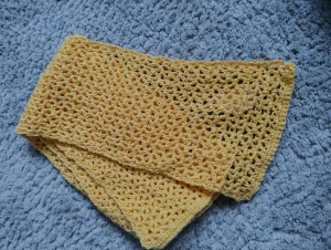 Handgjord virkad gul halsduk - Superfin handgjord virkad halsduk i en härlig gul färg som jag själv har gjort. Den är tunn, luftig och har ett snyggt hålmönster som ger en cool och unik look. Perfekt accessoar för att liva upp din outfit med lite färg och stil. 