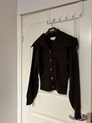 Mörkbrun kofta med stor krage - Snygg mörkbrun kofta från Ginatricot med stora knappar och en bred, markerad krage. 