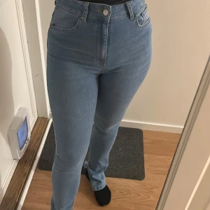 Ljusblå high waist bootcut jeans - Säljer ett par ljusblå jeans med hög midja bootcut och slits på insidan. Storlek S och använda en tillfälle.
