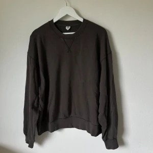 Olivgrön sweatshirt från Arket, L - En stilren olivgrön sweatshirt från Arket i storlek L. Tröjan har rund halsringning, långa ärmar och en relaxed passform. Tillverkad i mjuk bomull som känns skön mot huden. Perfekt för lager-på-lager under höst och vinter 2N1.