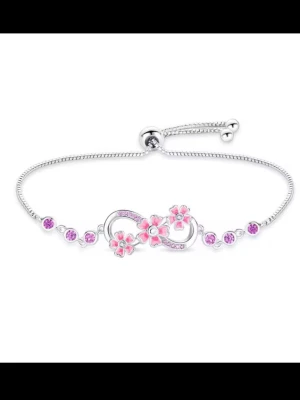 Silverarmband med rosa blommor - silverfärgad stål och med en snygg design med små rosa blommor och gnistrande stenar. De rosa och lila detaljerna ger en söt och feminin känsla, perfekt för dig som älskar mjuka färger och gulliga detaljer. Armbandet har en justerbar kedja som gör att det sitter bekvämt på handleden ✨
