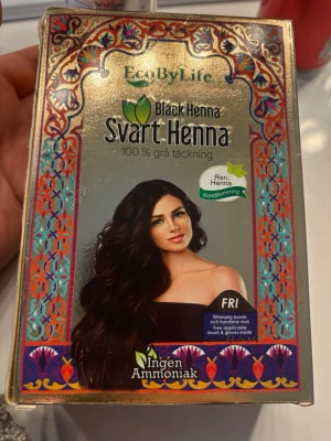EcoByLife Svart Henna hårfärg - Svart Henna hårfärg från EcoByLife med 100% grå täckning. Innehåller naturliga örter som amla, aloe vera, hibiskus och shikakai för silkeslent och glansigt hår. Fri från ammoniak och medföljer appliceringsborste och handskar. Ger en djup svart färg och vårdar håret.