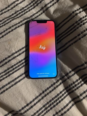 IPhone 13 - Blå iPhone 13 som är väldigt använd och i dålig kondition. Den funkar och går förmodligen att reparera.