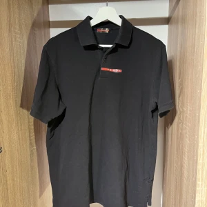 Prada pike, svart - Svart pikétröja från Prada med klassisk krage och korta ärmar. Klassisk logga, pris satt ex frakt