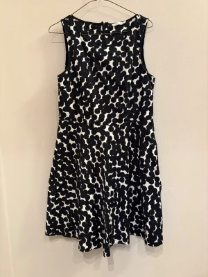 Svartvit prickig ärmlös klänning - Snygg ärmlös klänning från Stockh LM med svartvitt prickigt mönster. Modellen är kort och har en rund halsringning samt dragkedja i ryggen. Perfekt för dig som gillar grafiska prints och en klassisk men lekfull stil.