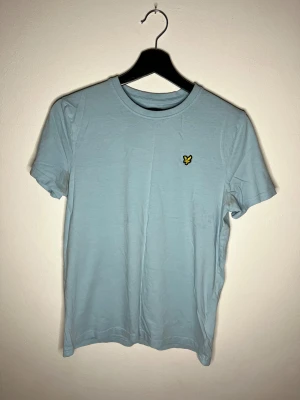 Lyle & Scott t-shirt ljusblå - Ljusblå Lyle & Scott t-shirt i bra skick men har fläck vid armhålorna, pm vid intresse.
 
 Storlek: 15/16 years