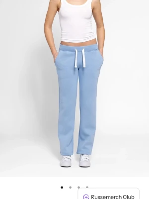 Ljusblå russemerch byxor - Snygga ljusblå mjukisbyxor med raka ben och vit snörning i midjan. Helt nya, köpta för 600kr