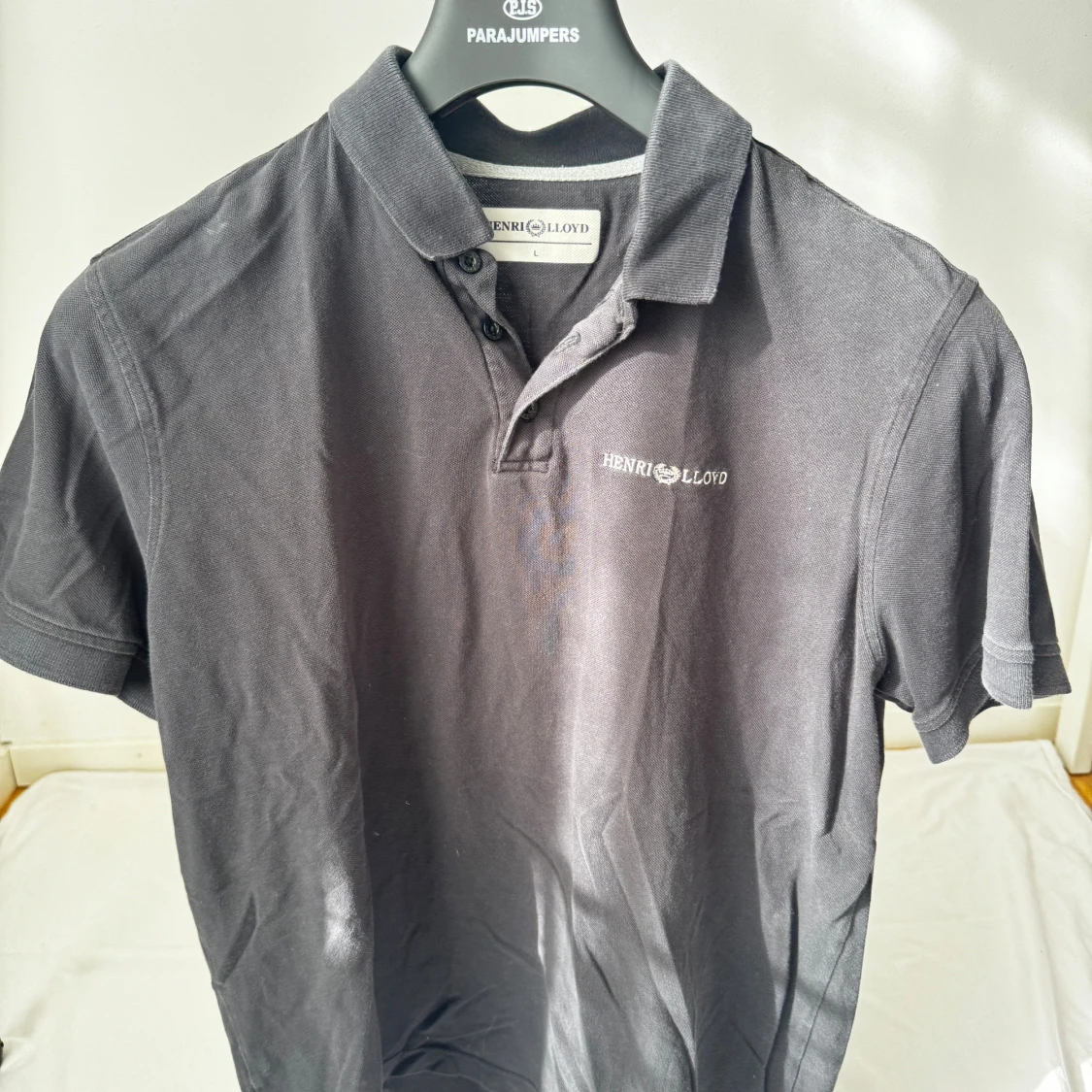 Svart pikétröja från Henri Lloyd